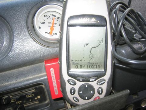 1987 Suzuki Samurai - Close-up of a vehicle's interior, showing a GPS unit and a water temperature gauge.