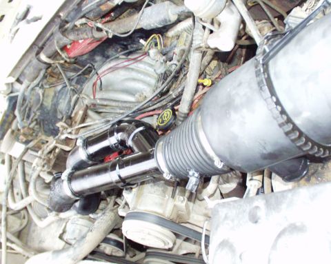 1989 Ford Bronco - Custom snorkel intake system installed in the engine bay of a vehicle.