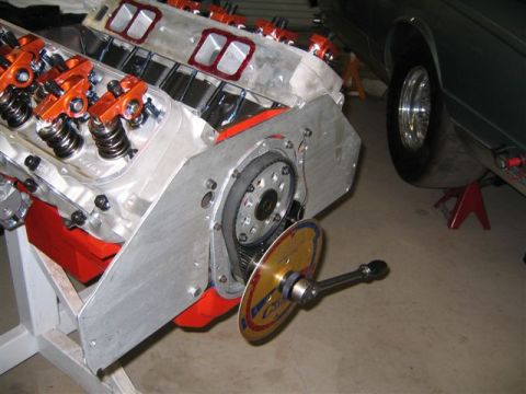 1995 Ford Bronco - Close-up of an engine's timing belt and pulley system, with a gauge tool attached.