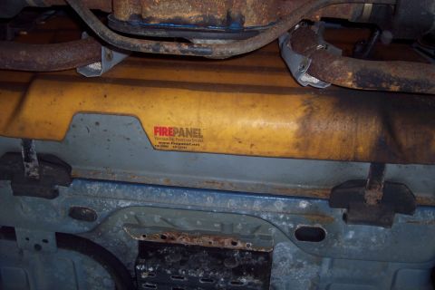 2001 Ford Crown Victoria - A yellow fire panel with a red FIREPANEL logo and website is visible on the undercarriage of a vehicle.