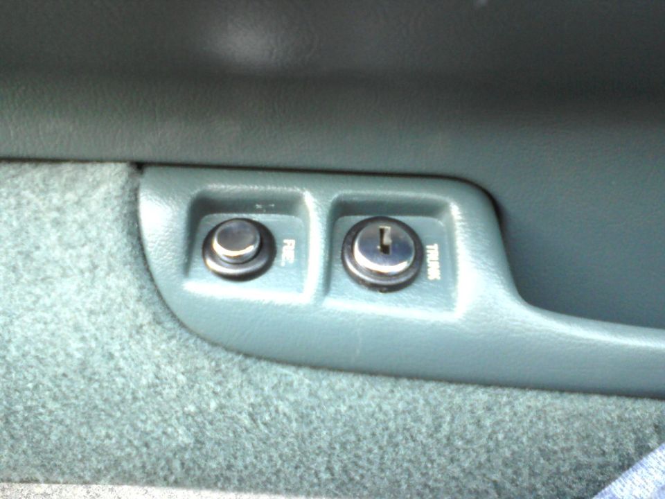 Fuel door switch and trunk release switch installed.