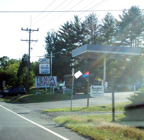 1971 Ford Ranchero - A gas station with multiple signs, including 'Tienda Hispana' and 'Seafood', under a canopy.