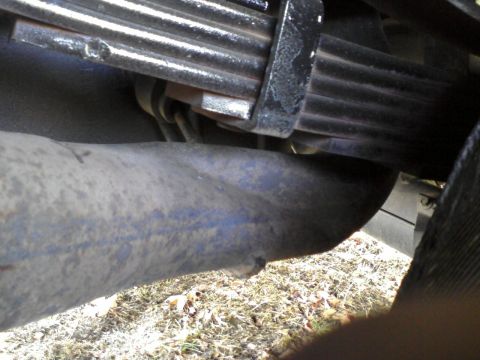 1996 Mercury Grand Marquis - Close-up view of a vehicle's suspension system, showing a leaf spring and axle component.