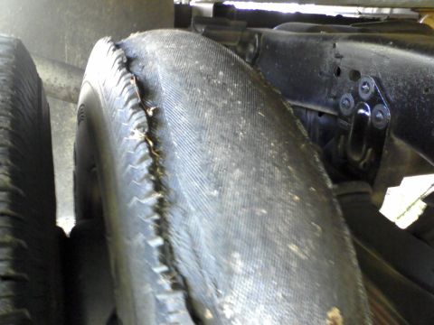 1996 Mercury Grand Marquis - A tire exhibits significant tread separation, indicating a potential safety hazard.