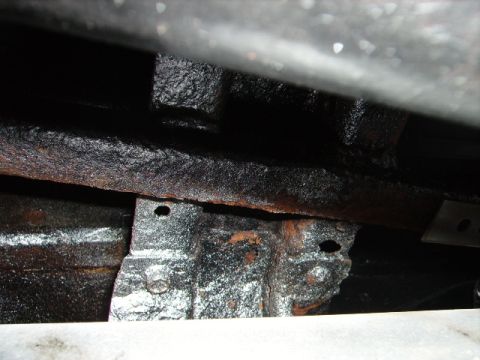 1978 Ford Bronco - The vehicle's undercarriage shows significant rust and wear, with visible frame components and mounting hardware.