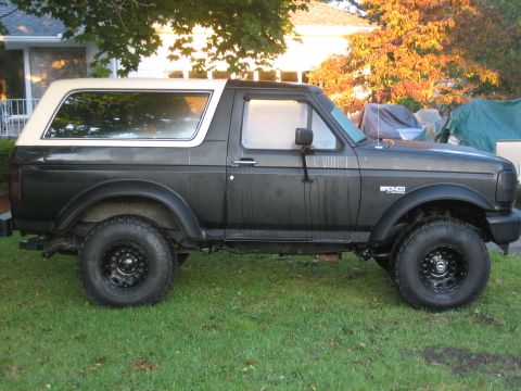 1995 Ford Bronco - This 1995 Ford Bronco is shown from the side, its dark gray body and white removable top.