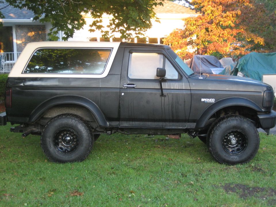 Side view of a 1995 Ford Bronco with a white top