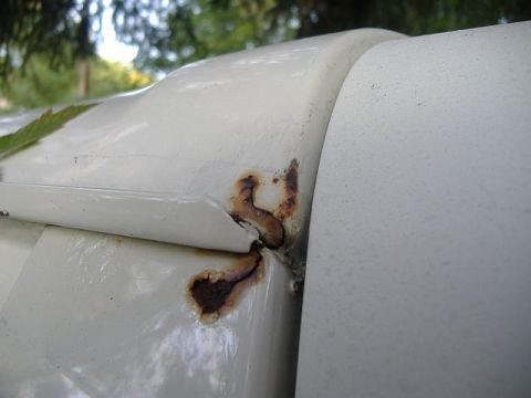 1987 Ford Bronco - Rust is visible on the body panel of a white vehicle, indicating areas of deterioration.