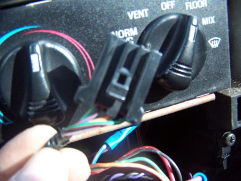 1994 Ford Probe - Interior view of climate controls with a wiring harness disconnected.