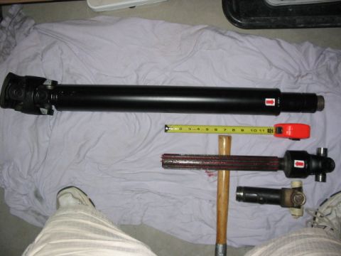 1995 Ford Bronco - Driveshafts and associated parts are displayed on a white cloth, with a tape measure for scale.
