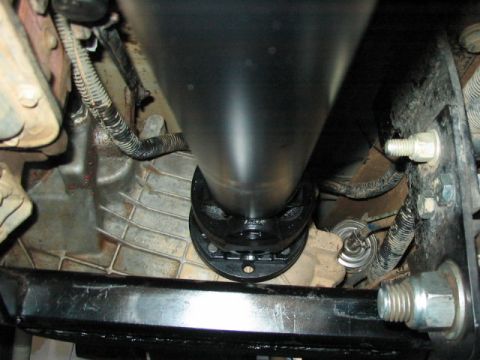 1995 Ford Bronco - Close-up view of the driveshaft and transmission housing, likely from an off-road vehicle.