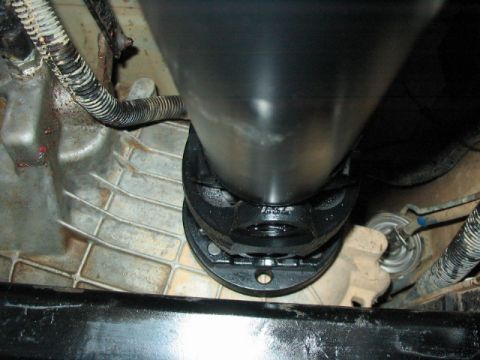 1995 Ford Bronco - Underside view of vehicle's driveshaft and transmission housing components.