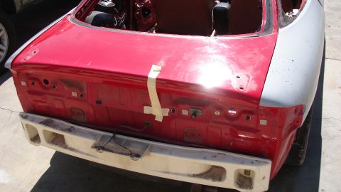 1996 Ford Probe - The rear of a car is shown, with the trunk lid removed and the bumper detached.