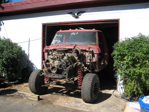 1990 Ford Bronco - This 1978 Ford F150 truck is missing its body panels and is partially inside a garage.