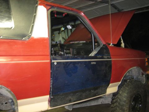 1990 Ford Bronco - 1990 Ford Bronco interior view with the driver's side door open.