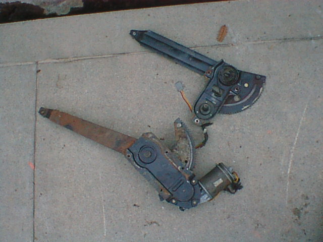 Here is the stock regulator next to the 86 F150 regulator. Originally, I was going to shorten the newer regulator to match the stock one but then I realized that the later door is about the same size as is the later window so I decided to try and use it as is. The really important part of doing this is being sure the new regulator is in the down position and then installing it with the window in the right spot for the fully lowered position and then figuring out where to drill the holes so that the regulator is in the right spot.