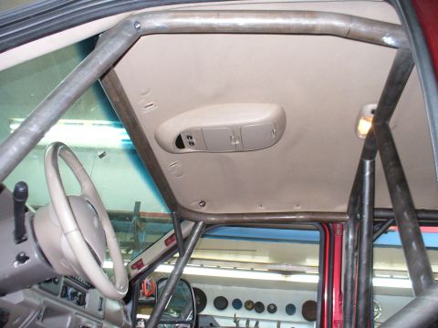 1978 Ford Bronco - The interior of a vehicle is shown with a custom roll cage installed.