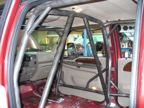 1978 Ford Bronco - This photo shows the interior of a red truck, focusing on the custom roll cage installation.