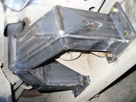 1978 Ford Bronco - Close-up view of custom metal fabrication and mounting hardware underneath a vehicle.