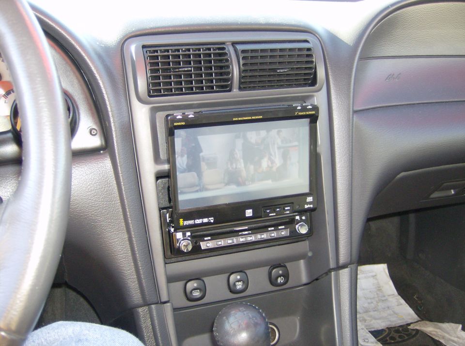 Gray Mustang dash with aftermarket Dual flip-out touchscreen DVD receiver playing video