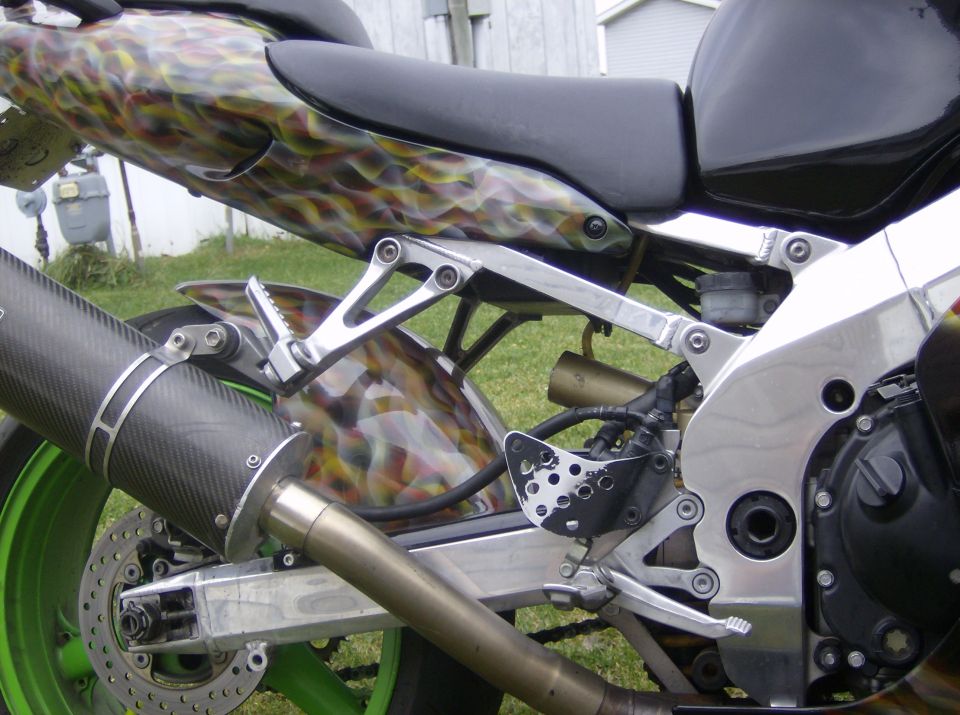 Rear of a sport motorcycle with carbon exhaust and camo-flame paint