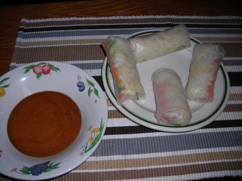 1984 Ford Bronco - Fresh spring rolls served with a side of peanut dipping sauce, presented on a striped placemat.