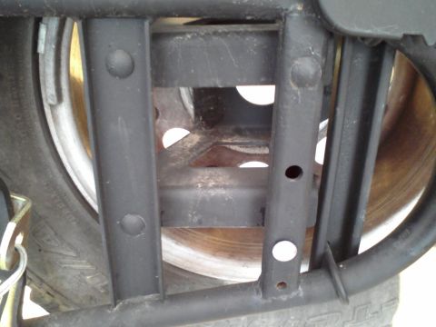 1992 Ford Bronco - Close-up of a black metal spare tire carrier, showing the tire and brake rotor. The registry claims this is a 1992 Ford Bronco modification.