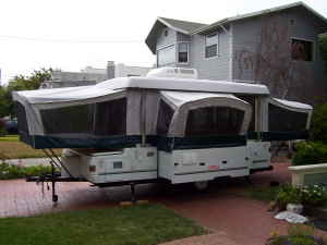1995 Ford Bronco - This pop-up camper trailer is set up in a residential driveway.
