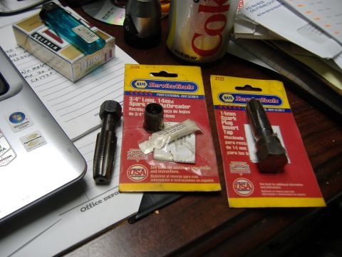 1996 Ford Crown Victoria - Tools for automotive repair are laid out on a desk next to a pack of cigarettes and a soda can.