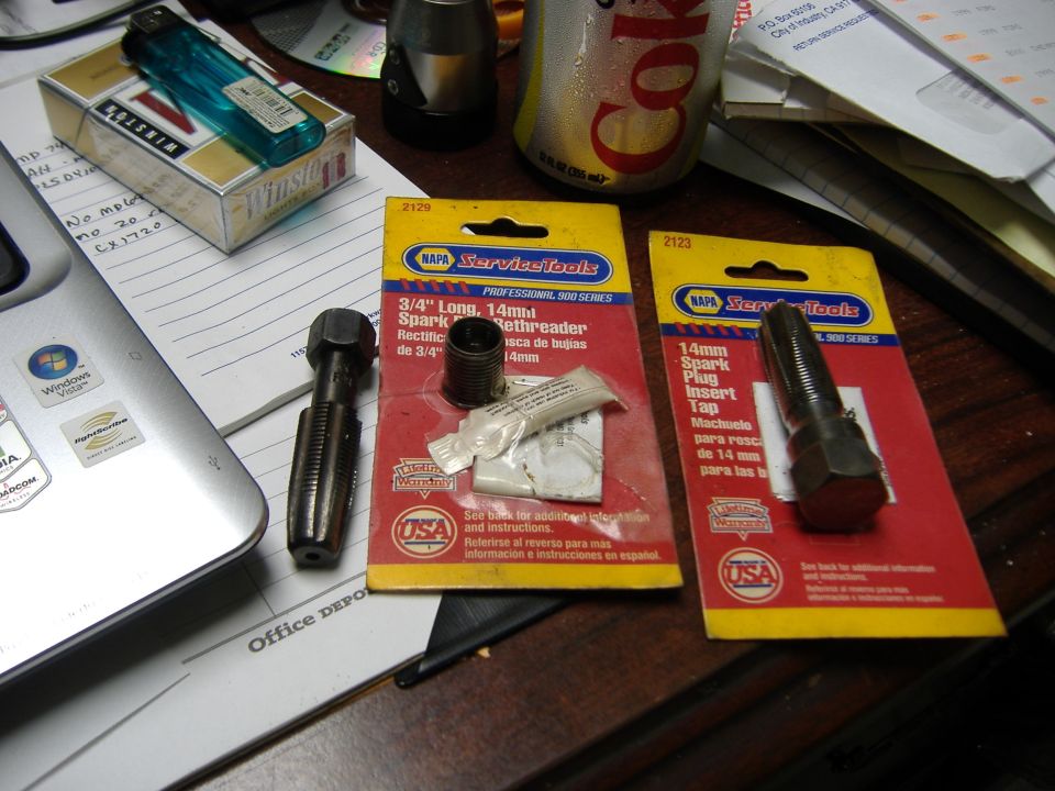 NAPA spark plug rethreader and insert tap tools on desk with Winston cigarettes and Coca-Cola can