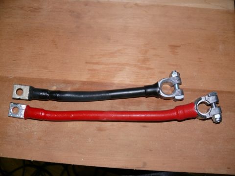 1988 Ford Bronco - Two battery cables are shown, one red and one black, with terminal clamps on each end.