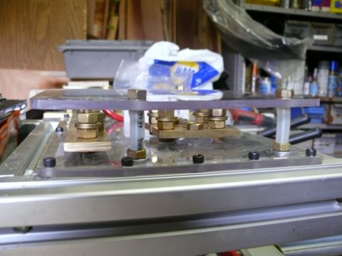 1988 Ford Bronco - This custom-built electrical terminal block features multiple brass connection points secured with nuts and bolts.