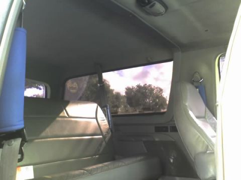 1995 Ford Bronco - Interior view of a vehicle with light gray upholstery and a blue strap hanging from the ceiling.