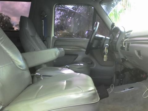 1995 Ford Bronco - Interior view of a 1995 Ford Bronco, showing the gray leather bucket seats and dashboard.
