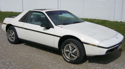 1971 Ford Ranchero - White Pontiac Fiero from the front three-quarter angle, parked outdoors.