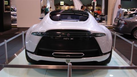 1996 Ford Probe - Rear view of a white Saab Aero X concept car with Aero X badge displayed on a stand at an indoor auto show