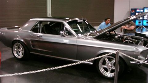 1996 Ford Probe - Customized 1967 Ford Mustang coupe on display at an auto show.