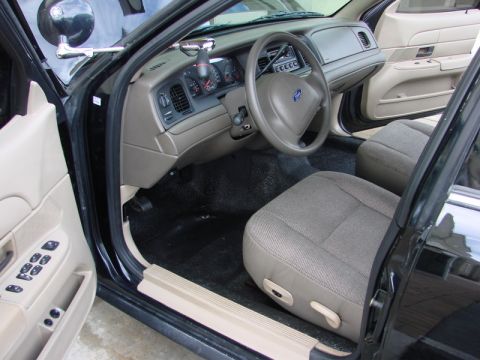 1998 Ford Crown Victoria - The interior of a 1998 Ford Crown Victoria is visible, the dashboard, steering wheel, and front seats.
