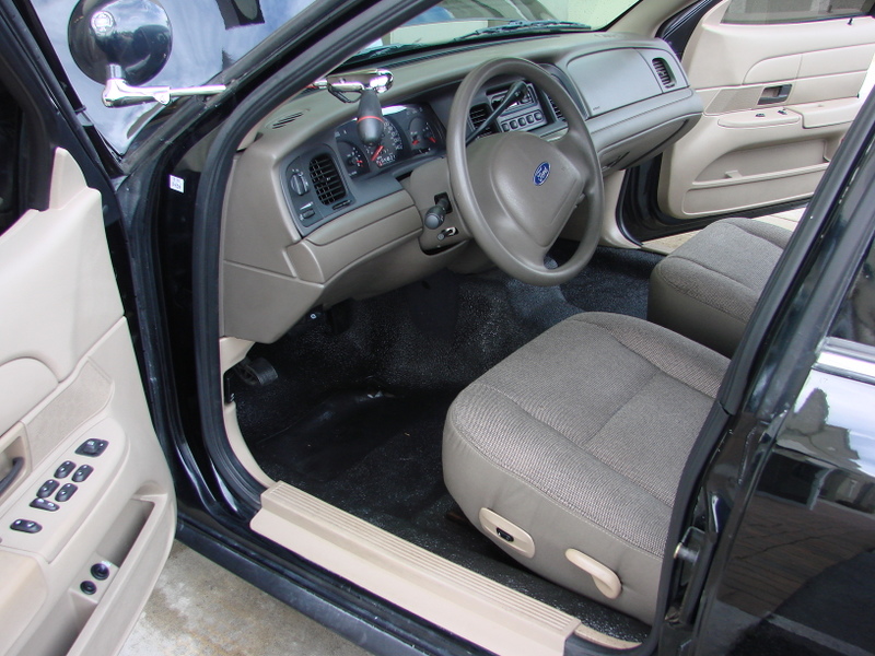 Interior view of a 1998 Ford Crown Victoria showing the dashboard, steering wheel, and seats