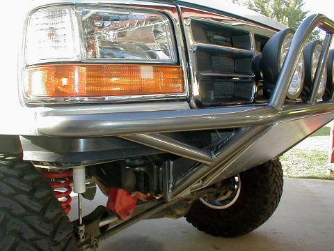 1996 Ford Bronco - Close-up of a modified front bumper and grille on a white Ford F-Series truck.
