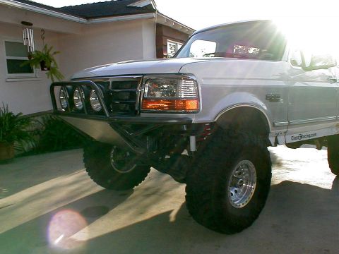 1996 Ford Bronco - This 1996 Ford Bronco features a custom front bumper with integrated lights and a skid plate, along with a lifted suspension.