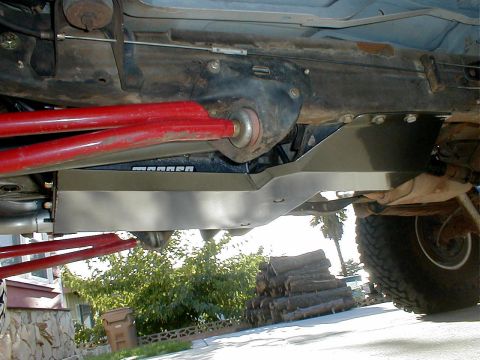 1996 Ford Bronco - Close-up view of a vehicle's undercarriage, showing a skid plate and suspension components.