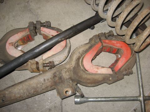 1988 Ford Bronco - Close-up view of suspension components, including red bushings and coil springs, likely for a vehicle.