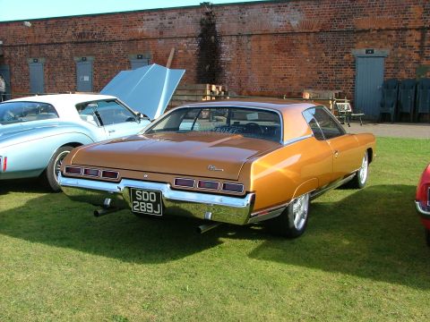 1988 Ford Sport - Rear view of a 1971 Chevrolet Caprice coupe parked on grass with another vehicle nearby.