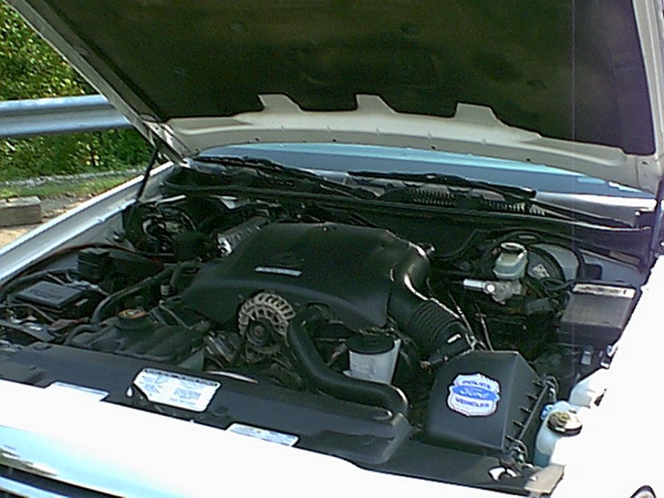 1998 Ford Crown Victoria engine compartment with hood open, showing V8 engine, air intake, and brake fluid reservoir