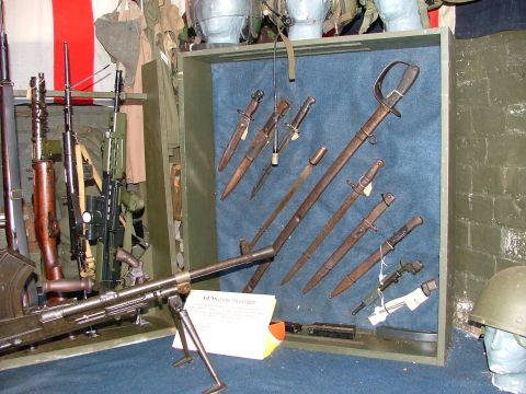1988 Ford Sport - A collection of historical firearms and bayonets are displayed, with a helmet visible on the side.