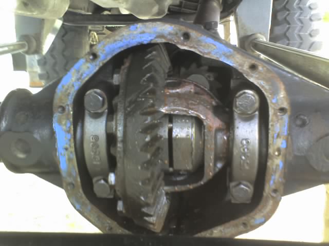 close-up of open differential housing with gears visible, blue paint on housing edge