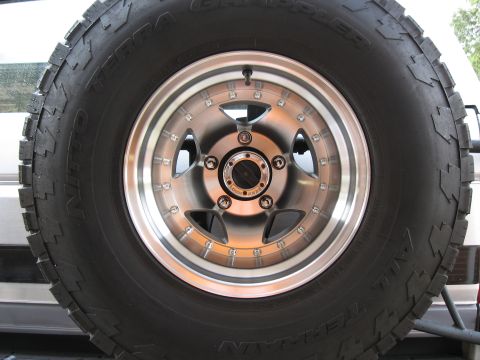 1994 Ford Bronco - Spare tire and wheel assembly on the back of a vehicle, showing a Nitto Terra Grappler tire.