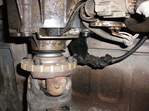 1995 Ford Bronco - Underside view of vehicle driveshaft and transfer case assembly with visible wiring.