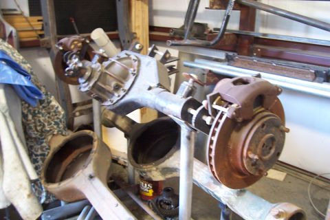 1995 Ford Bronco - A disassembled vehicle rear axle assembly is shown, with brake components attached.